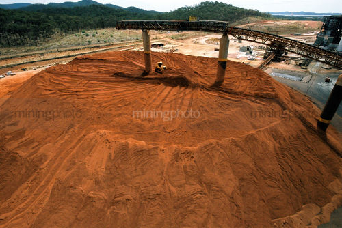Stockpiled product and large conveyor at processing plant. - Mining Photo Stock Library