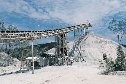 Conveyor stockpiling product on open cut mine site. - Mining Photo Stock Library