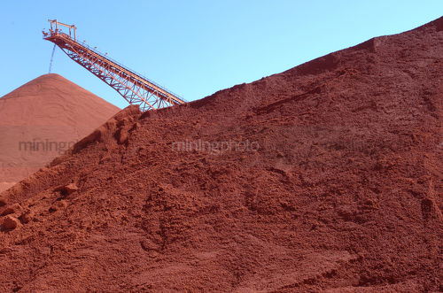 Conveyor stockpiling bauxite - Mining Photo Stock Library