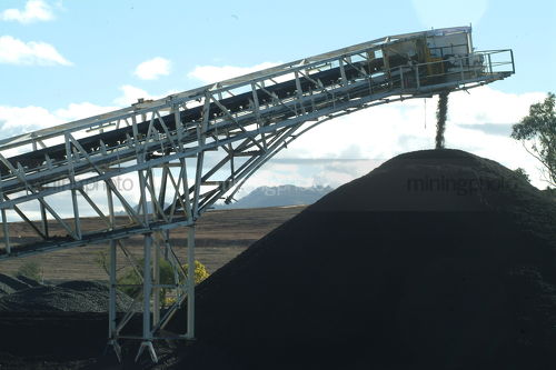Conveyor stockpiling coal - Mining Photo Stock Library