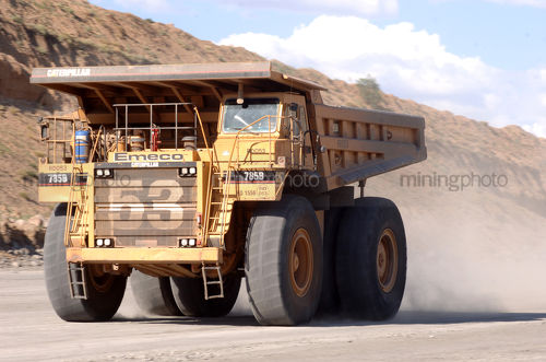 Mine site haul truck moving along haul road - Mining Photo Stock Library