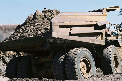 Loaded truck driving up haul road  on open cut mine site. - Mining Photo Stock Library