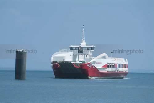 Car ferry barge about to dock at wharf - Mining Photo Stock Library