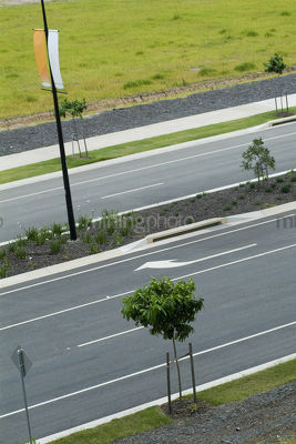 Closeup looking across double lane road with nature strip planting - Mining Photo Stock Library