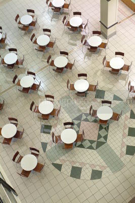 Chairs and tables arranged inside a shopping centre.  shot from above - Mining Photo Stock Library