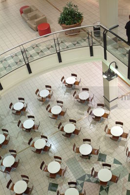 Chairs and tables arranged inside a shopping centre.  shot from above - Mining Photo Stock Library