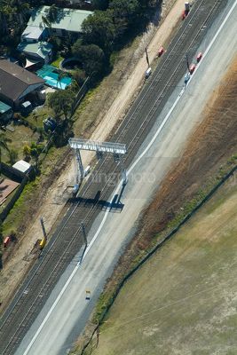 Domestic light rail tracks next to residential house. aerial shot - Mining Photo Stock Library