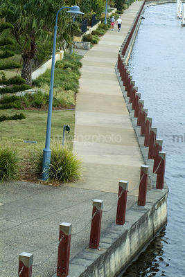 People on walkway along waterfront residential subdivision with marina and jetty adjacent.
aerial shot - Mining Photo Stock Library