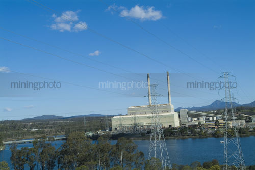 Power station with lake in foreground - Mining Photo Stock Library
