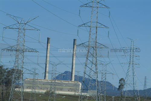 Electricity towers with power station in foreground. - Mining Photo Stock Library