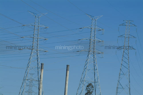 Electricity towers overland carrying power from power station to city. - Mining Photo Stock Library