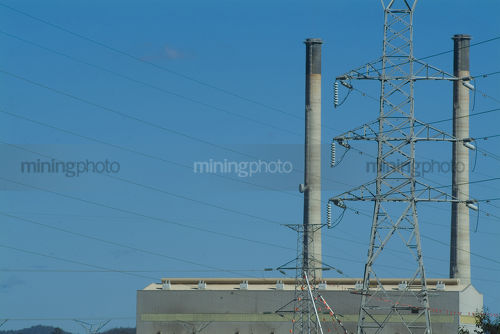 Cooling tower and power station with electricity tower in background. - Mining Photo Stock Library