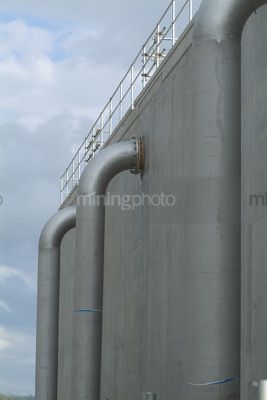 Large diameter right angle water pipes at treatment plant - Mining Photo Stock Library