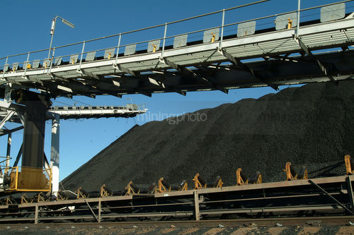 Coal loader and conveyor stockpiling at rail port - Mining Photo Stock Library