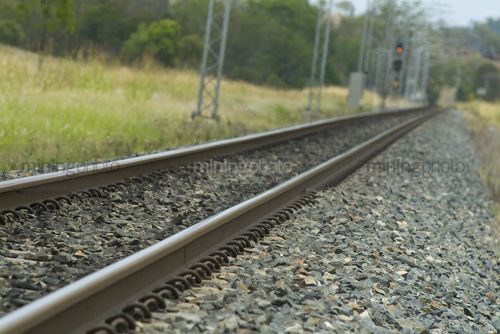 Close up of heavy rail track disappearing into out of focus distance. - Mining Photo Stock Library