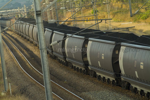 Coal loaded heavy rail carriages on track. - Mining Photo Stock Library