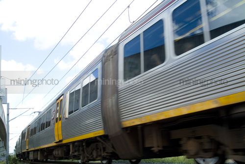 Light rail passenger train moving. shot up close from track level. - Mining Photo Stock Library