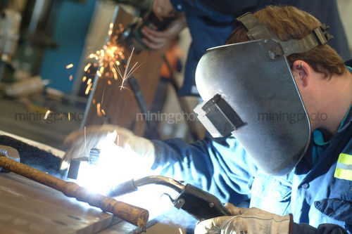 Welder up close with mask on - Mining Photo Stock Library