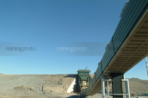 Hopper and coal covered conveyor being constructed - Mining Photo Stock Library