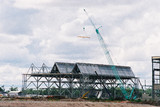 Mining Photo Stock Library - cranes lifting roofing into place over steel construction for building of a factory  ( Weight: 4  New Image: NO)