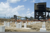 Mining Photo Stock Library - construction of coal terminal port expansion. male workers in PPE with pre cast concrete pillars ( Weight: 2  New Image: NO)