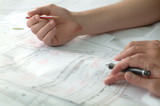 Mining Photo Stock Library - closeup of hands with pen and pencil above engineering plans. good generic shot ( Weight: 2  New Image: NO)