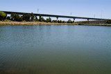 Mining Photo Stock Library - looking across large dam to aerial rail bridge flyover.   ( Weight: 1  New Image: NO)