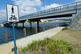 Mining Photo Stock Library - road bridge over lake in residential community with bike track sign in foreground ( Weight: 1  New Image: NO)