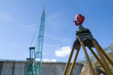 Mining Photo Stock Library - surveyors survey tool on dam construction site with travel crane in background. ( Weight: 3  New Image: NO)