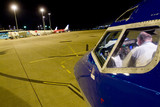 Mining Photo Stock Library - pilot in plane checking procedures at airport at nigth.  shot from outside plane looking in and from over pilots back. ( Weight: 1  New Image: NO)