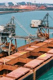 Mining Photo Stock Library - ship loader conveyor loading bauxite into ships holds with processing plant in background. aerial shot. ( Weight: 1  New Image: NO)