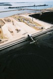 Mining Photo Stock Library - aerial shot of coal stockpile with port construction and shiploading terminal in background ( Weight: 1  New Image: NO)