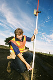 Mining Photo Stock Library - road surveyor in ppe checking levels of rural road during upgrade. blue sky ( Weight: 4  New Image: NO)