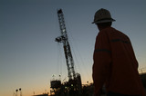 Mining Photo Stock Library - Silhouette of a drill rig worker with the derrick behind at dusk. ( Weight: 1  New Image: NO)