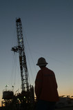 Mining Photo Stock Library - Silhouette of a drill rig worker with the derrick behind at dusk. ( Weight: 1  New Image: NO)
