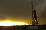 Mining Photo Stock Library - drill rig and derrick shot at sunset with storm behind ( Weight: 1  New Image: NO)
