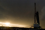 Mining Photo Stock Library - drill rig and derrick shot at sunset with storm behind ( Weight: 3  New Image: NO)