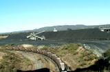 Mining Photo Stock Library - coal train being loaded at coal mine site with reclaimer and coal stockpiles in background. ( Weight: 3  New Image: NO)