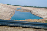 Mining Photo Stock Library - half full dam with black water pipe in foreground ( Weight: 4  New Image: NO)