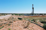 Mining Photo Stock Library - drill rig in the desert with vegetation and sandy soil in foreground ( Weight: 3  New Image: NO)