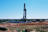 Mining Photo Stock Library - drill rig in the desert with vegetation and sandy soil in foreground ( Weight: 3  New Image: NO)