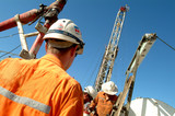 Mining Photo Stock Library - drill rig workers with derrick behind.  shot from behind. ( Weight: 1  New Image: NO)