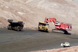 Mining Photo Stock Library - large excavator loading a haul truck while an empty truck is nearby.  light vehicle in foreground for scale.  opencut mine site. ( Weight: 1  New Image: NO)