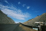 Mining Photo Stock Library - conveyor leaving underground mine and traveling up graded road.  blue sky in background.  ( Weight: 2  New Image: NO)