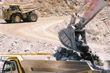 Mining Photo Stock Library - excavator bucket loading hard metal into haul truck with empty truck in background on haul road. ( Weight: 2  New Image: NO)