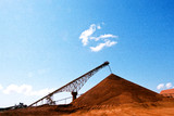 Mining Photo Stock Library - conveyor stockpiling red dirt with brilliant blue sky behind. ( Weight: 1  New Image: NO)