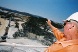 Mining Photo Stock Library - mine supervisor looking out over the processing plant and tailings dam from atop the high conveyor.  shot from the side. ( Weight: 1  New Image: NO)