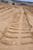 Mining Photo Stock Library - creative long shot looking along truck tyre track to truck in distance ( Weight: 1  New Image: NO)
