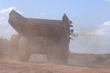 Mining Photo Stock Library - dusty shot from behind of haul truck traveling along haul road. ( Weight: 3  New Image: NO)