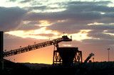 Mining Photo Stock Library - Silhouette of a conveyor delivering product to hopper with sunset behind. ( Weight: 2  New Image: NO)